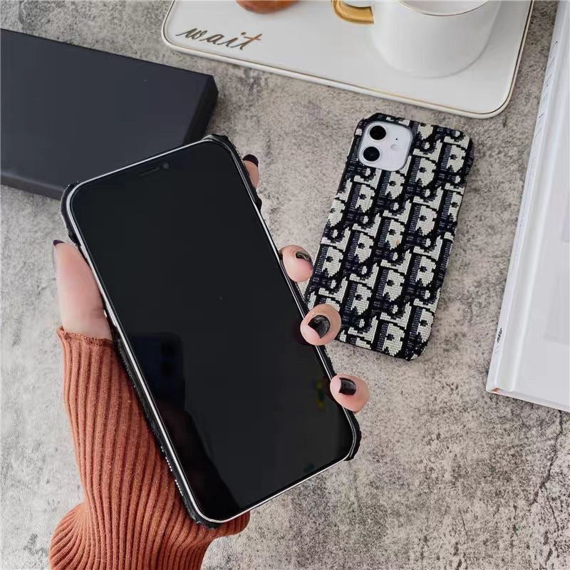 Casing iPhone berbahan kain bordir merek fashion